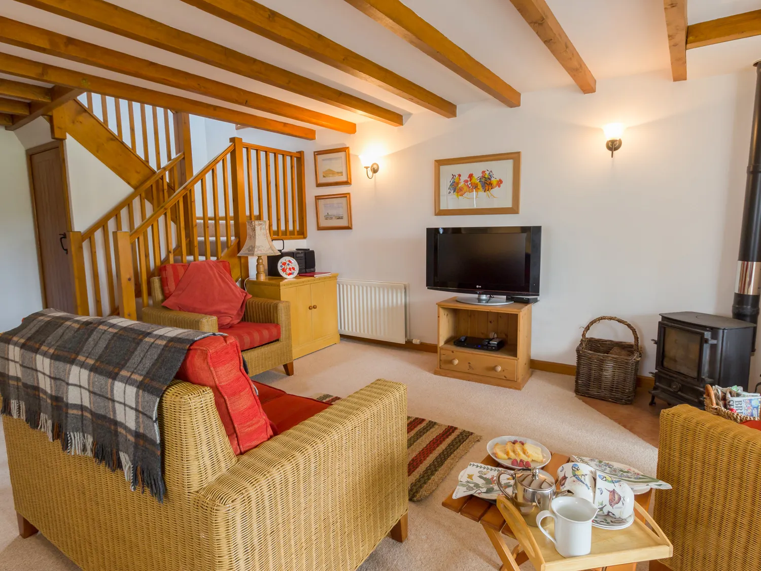 The Bothy, Lowick | A cosy living room at The Bothy with a wood-burning stove and comfortable seating.