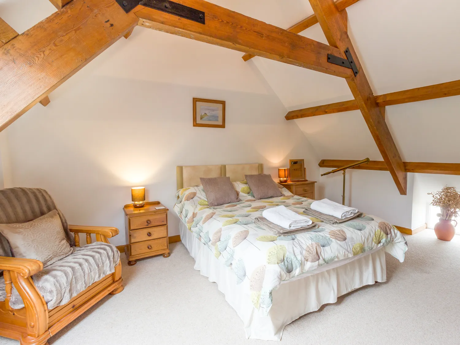 A spacious master bedroom at The Bothy with a king-sized bed and rustic décor.